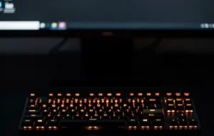 Minimalist dark setup with a backlit keyboard representing high-focus work and enterprise productivity